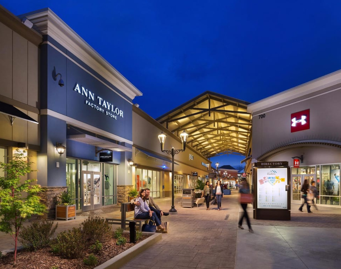 Exterior of Asheville Outlets with shoppers walking between stores