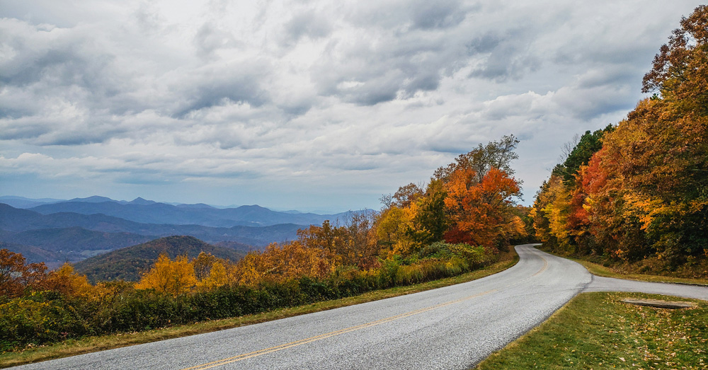 Blue Ridge Parkway overlook with layered mountain ridges and scenic sky